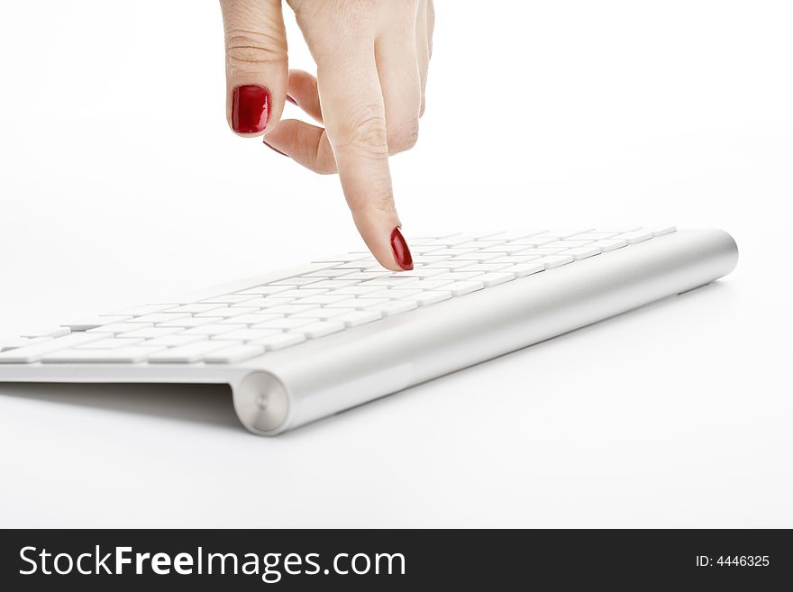 Fingers with red nail touching keyboard