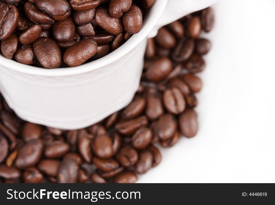 Close-up of a coffee cup filled with coffee beans