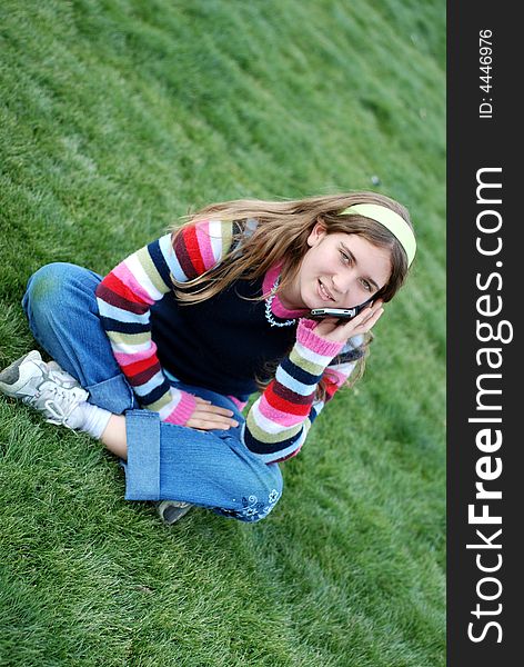 Young blond girl in the park and cell phone. Young blond girl in the park and cell phone