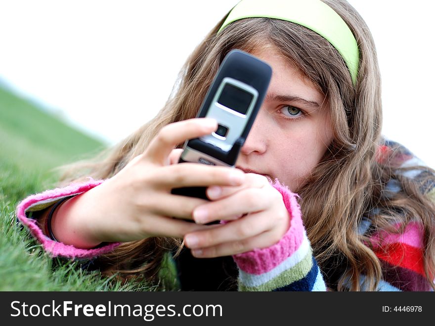 Young blond girl in the park and cell phone. Young blond girl in the park and cell phone