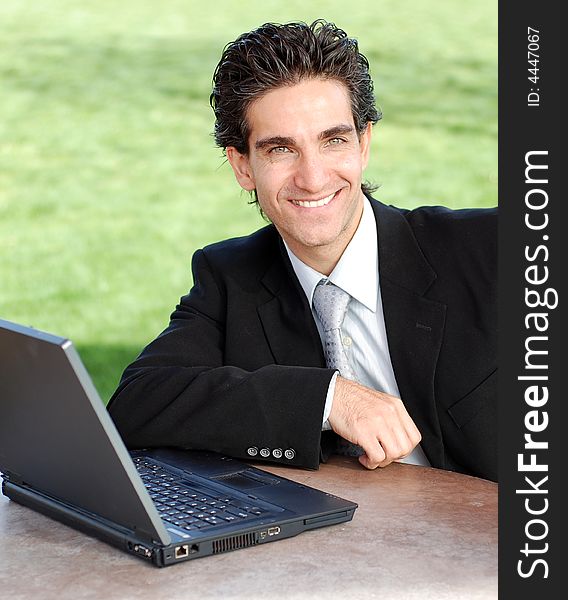 Confident and successful young adult businessman working on his laptop computer. Confident and successful young adult businessman working on his laptop computer