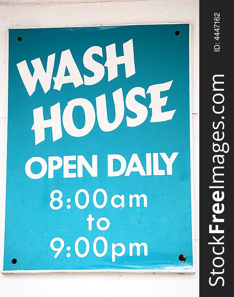 Wash house sign with hours posted. Wash house sign with hours posted.