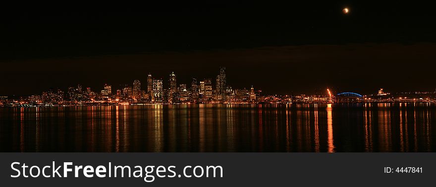 View of the Seattle skyline with moon almost at full lunar eclipse. View of the Seattle skyline with moon almost at full lunar eclipse