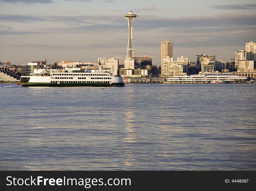 A ferry slowly moves past the Seattle skyline. A ferry slowly moves past the Seattle skyline