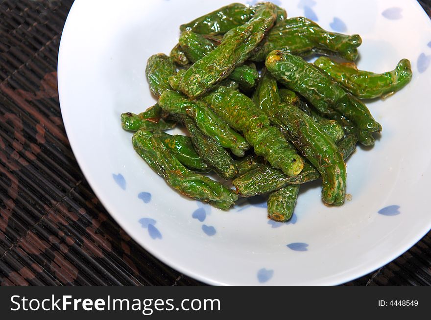 Image of a bowl of spicy japanese fried green peppers. Image of a bowl of spicy japanese fried green peppers