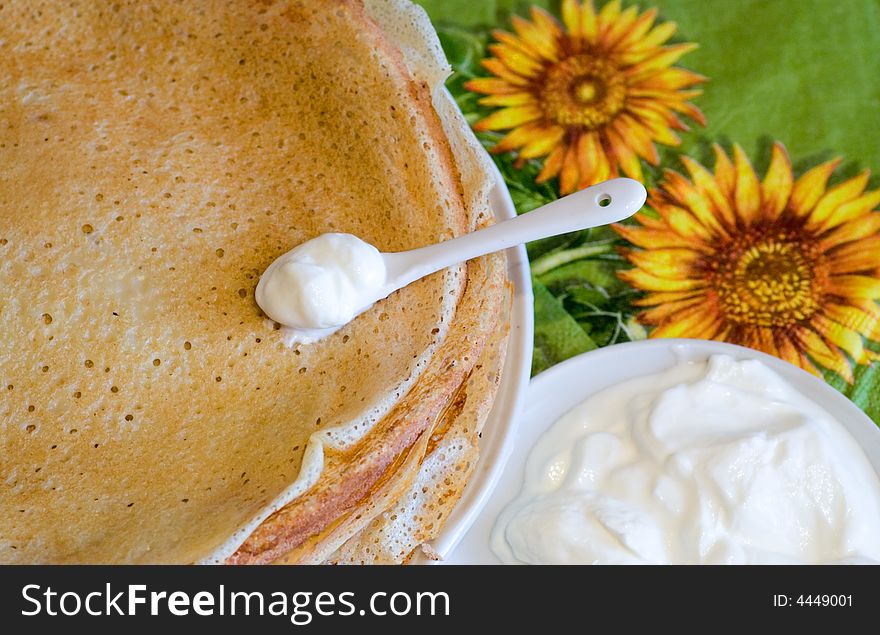 Pancakes with sour (macro) and napkins with sunflower