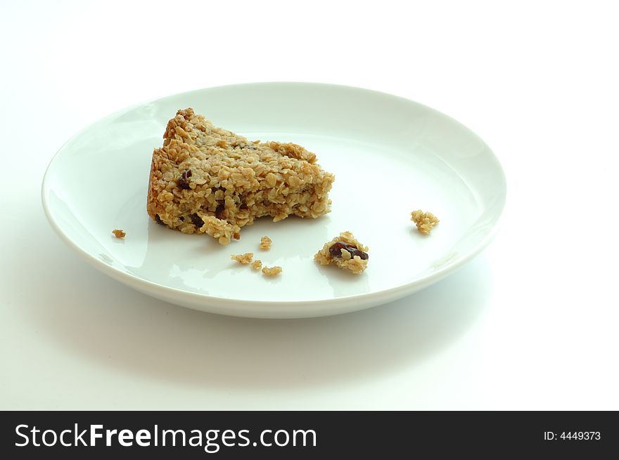 Flapjack oat bars on a white plate isolated on white. Flapjack oat bars on a white plate isolated on white