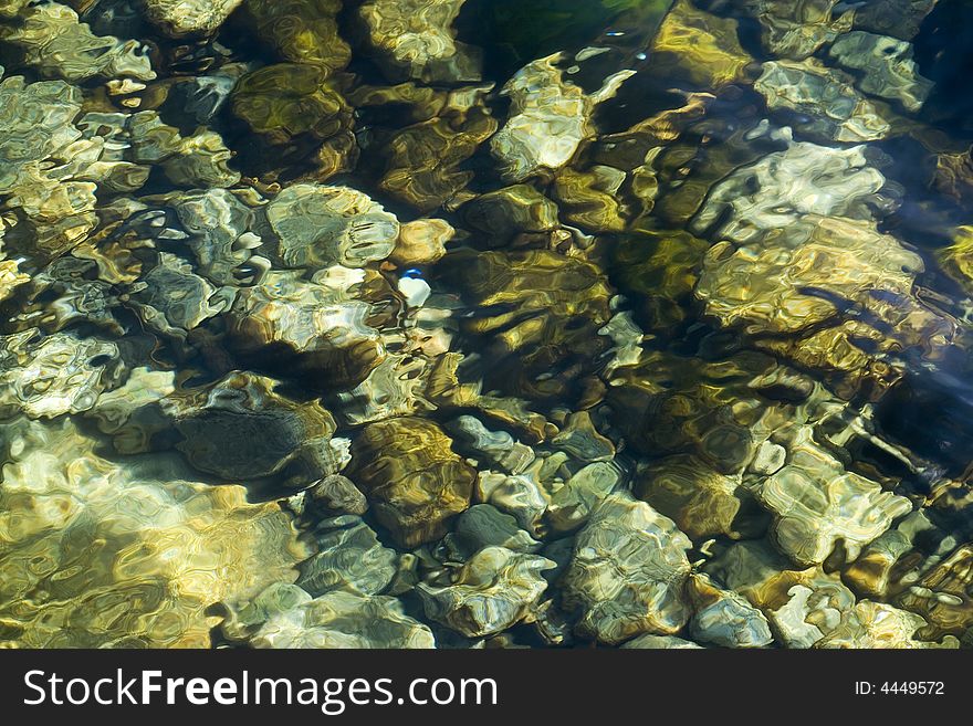 Sea stone illuminated by bright sunshines