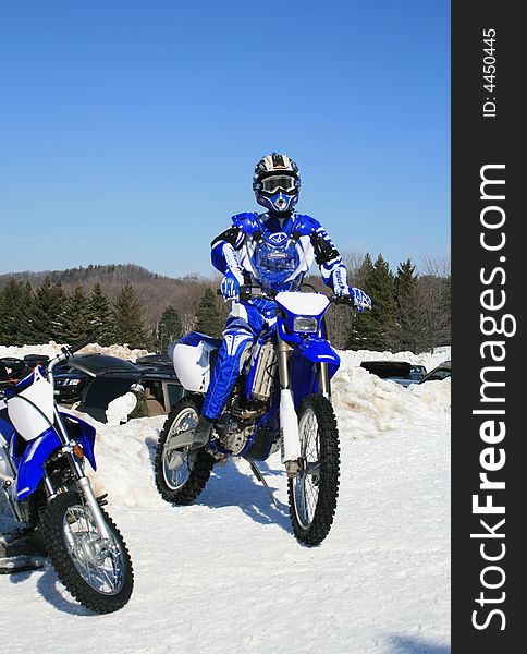 Motorcyclist  on motorcycle in winter landscape