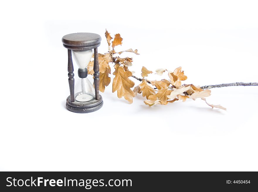 Sand-glass and fall oak on white background. Sand-glass and fall oak on white background