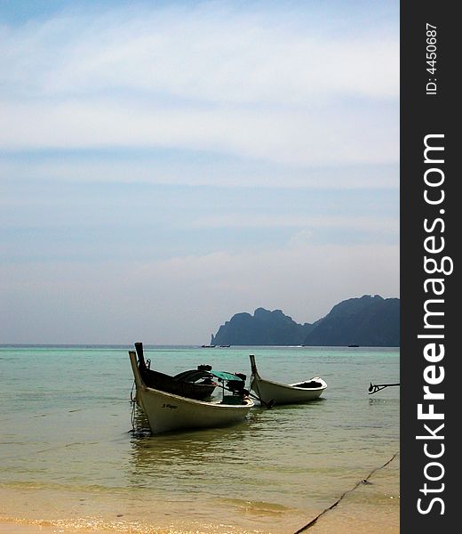 White boats parked at the beach of phiphi island