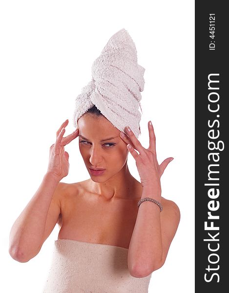 Beautiful woman with towel on her head doing massage on her forehead