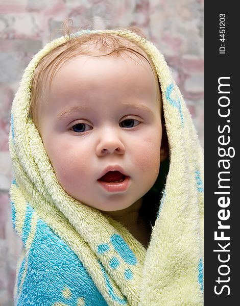 Baby after bath under towel