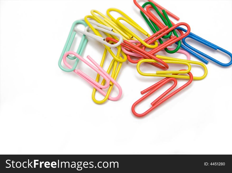 Multicolored paper-clip on the white isolated background