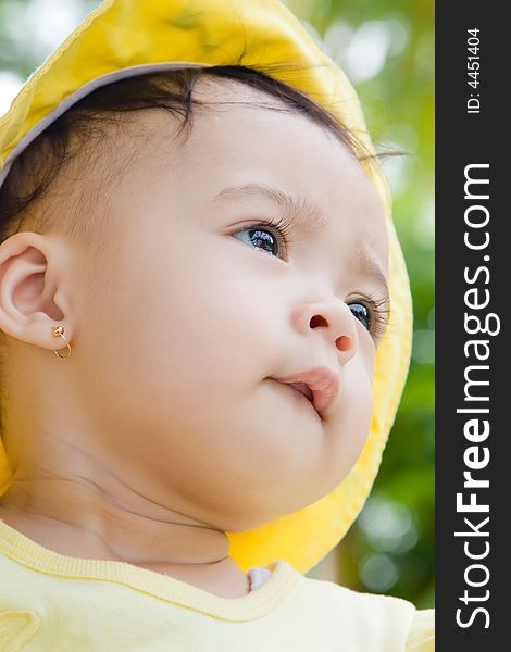 Close up photo of beautiful child wearing yellow hat. Close up photo of beautiful child wearing yellow hat