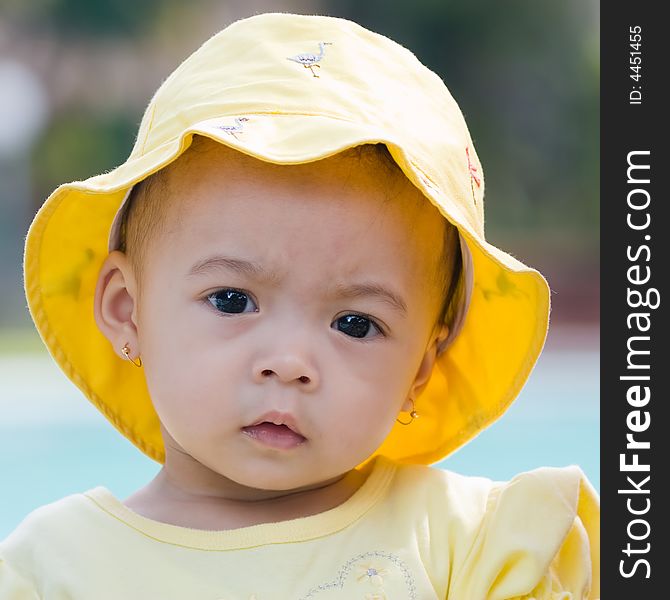 Close up photo of beautiful child wearing yellow hat