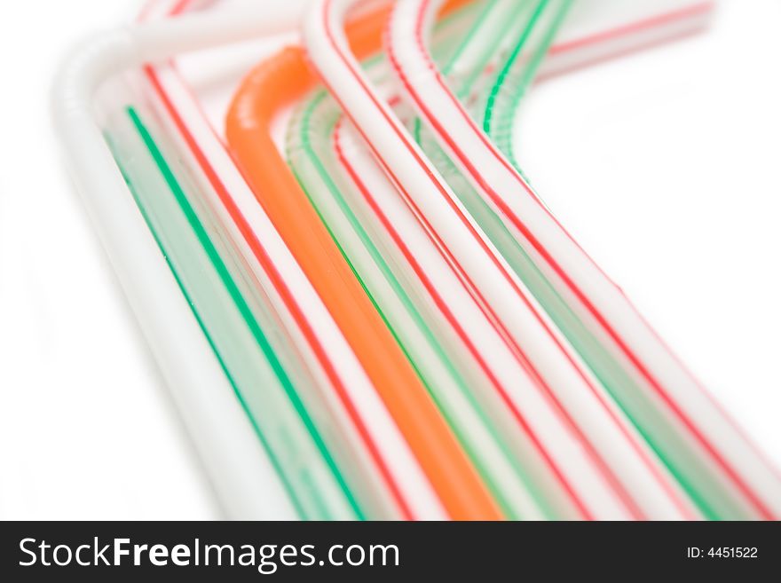 Multicolored tubes from juice on white background