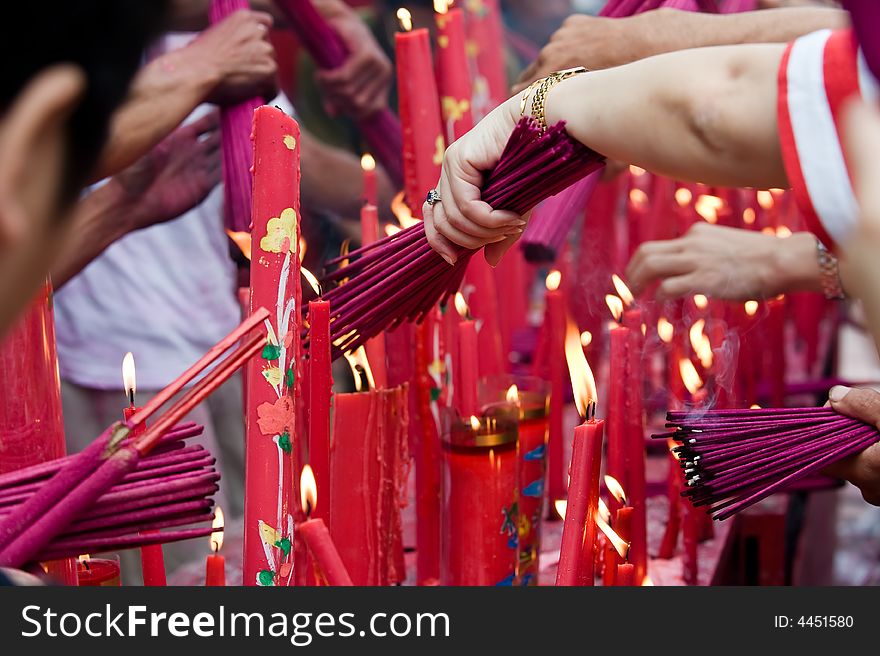 Photo of people burning an incense at the temple. Photo of people burning an incense at the temple