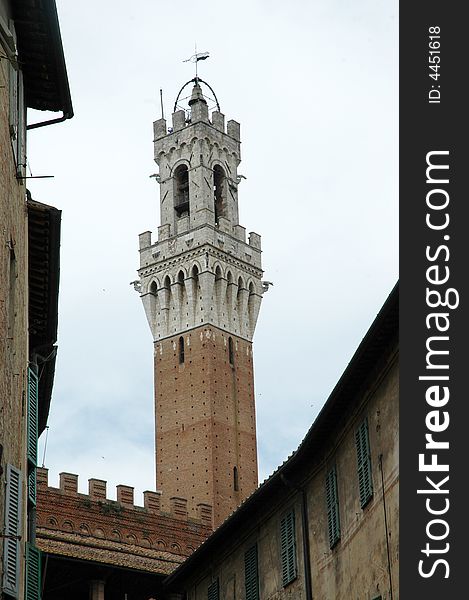 The tower of the Palazzo Pubblico of Siena from below.Tuscany,Italy. Palio square . The tower of the Palazzo Pubblico of Siena from below.Tuscany,Italy. Palio square