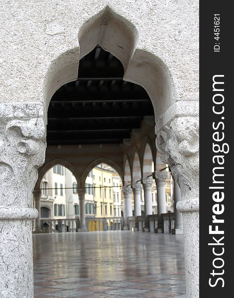 Architectural view of an Orient-style balustrade opening a view to a marble floor and covered terrace with pillars and colorful buildings background. Architectural view of an Orient-style balustrade opening a view to a marble floor and covered terrace with pillars and colorful buildings background