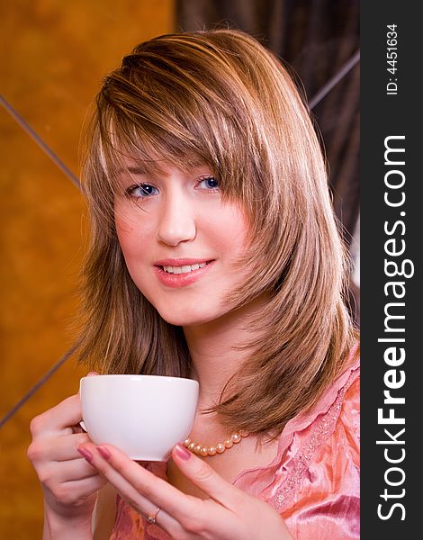 Smiley young woman with cup in hands