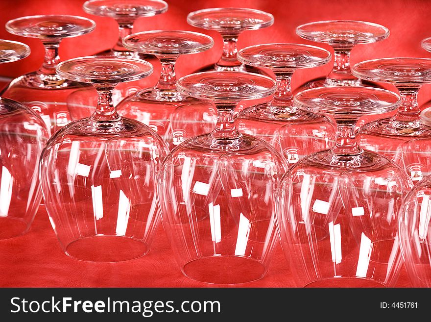 Empty wine glasses on red background