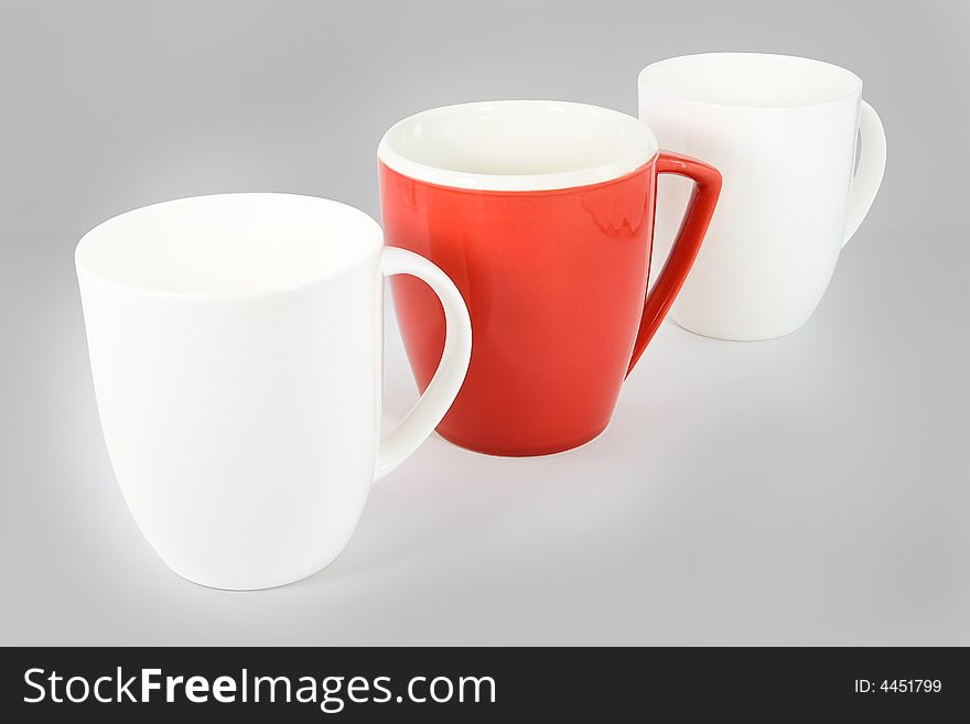 Set of three coffee mugs on graduated gray background