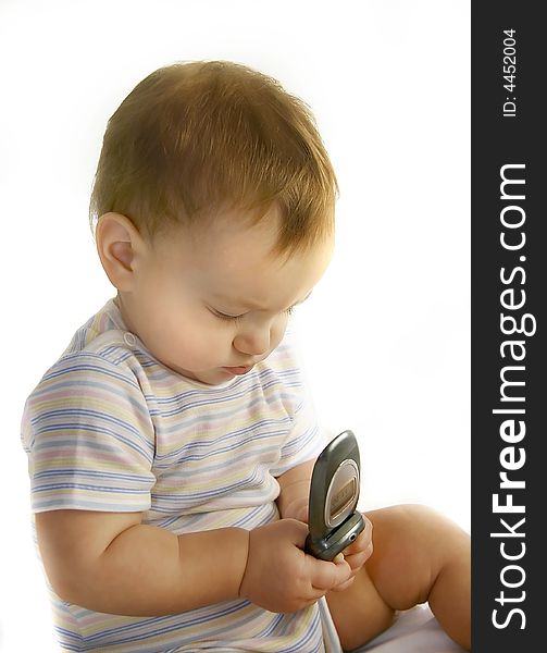 Baby boy with cell phone over white