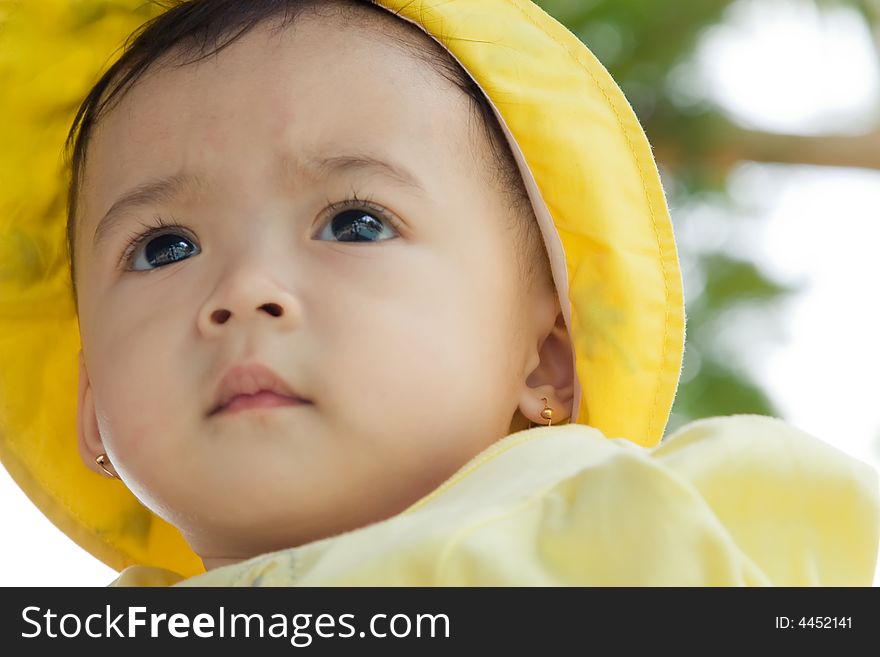 Close up photo of beautiful child wearing yellow hat. Close up photo of beautiful child wearing yellow hat