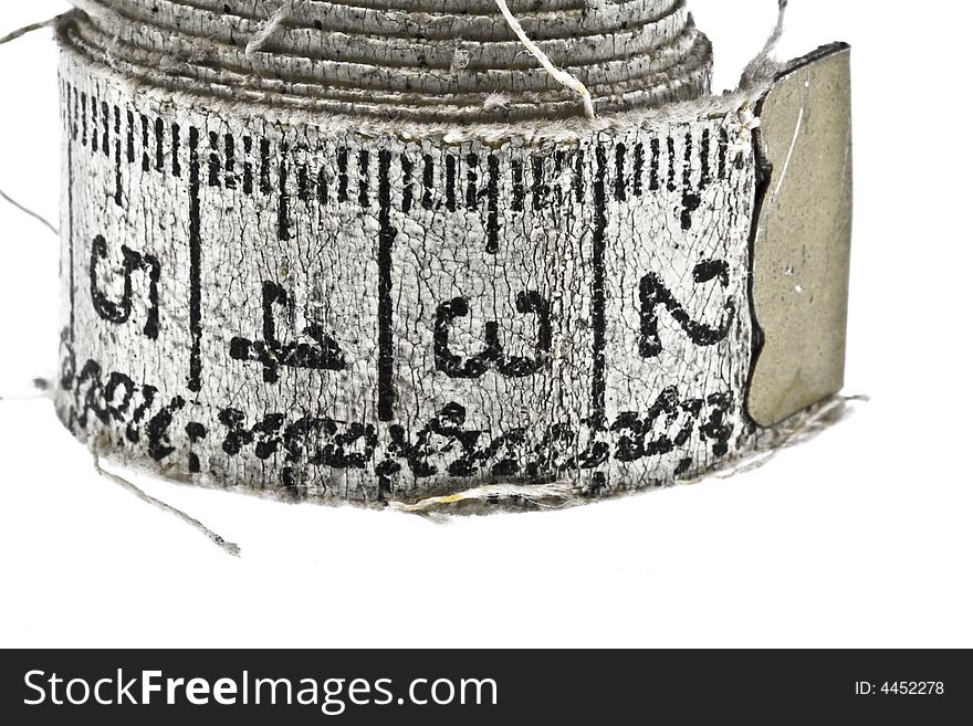 Old measuring tape isolated on white
