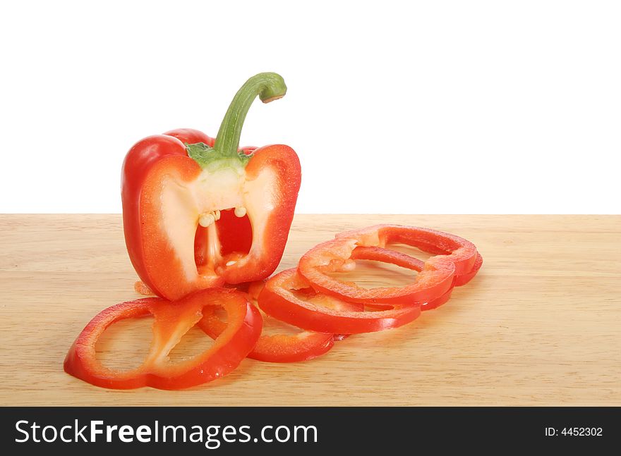 Sliced red pepper on a wooden board