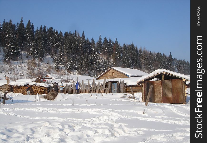 Wood cabins in snow mountain