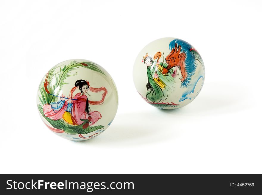 Two oriental balls with drawings on a white background