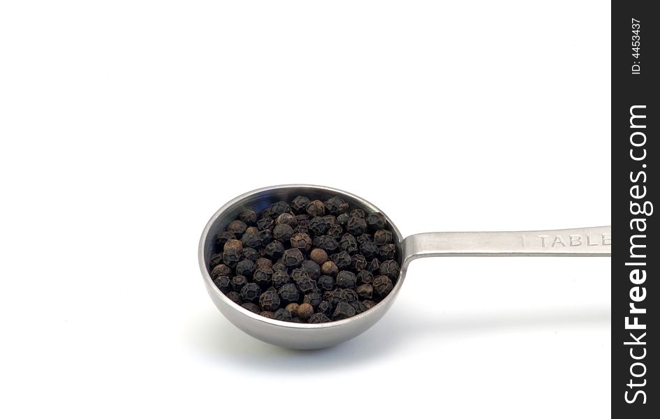 Isolated shot of pepper in a measuring spoon on a white background. Isolated shot of pepper in a measuring spoon on a white background.