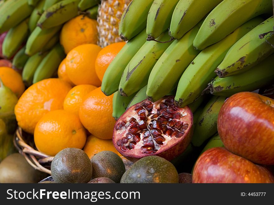 Tropica fruits: pomegranate, bananas oranges.