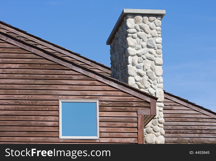 A shake roof against blue sky with space for text. A shake roof against blue sky with space for text