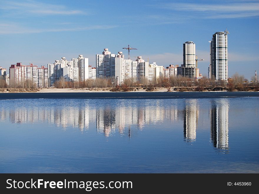 Day city view mirroring in water. Day city view mirroring in water