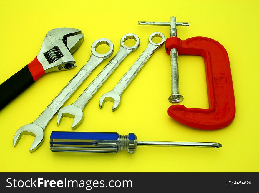 Several tools over a yellow surface