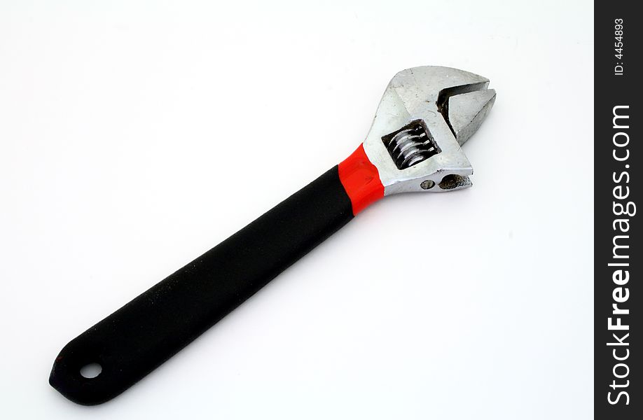 Adjustable wrench over a white surface