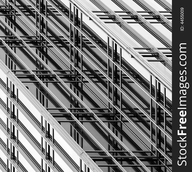 Square format, diagonal composition, black and white photo abstract of ornamental lattice on the exterior curtain wall of an office building. Square format, diagonal composition, black and white photo abstract of ornamental lattice on the exterior curtain wall of an office building.