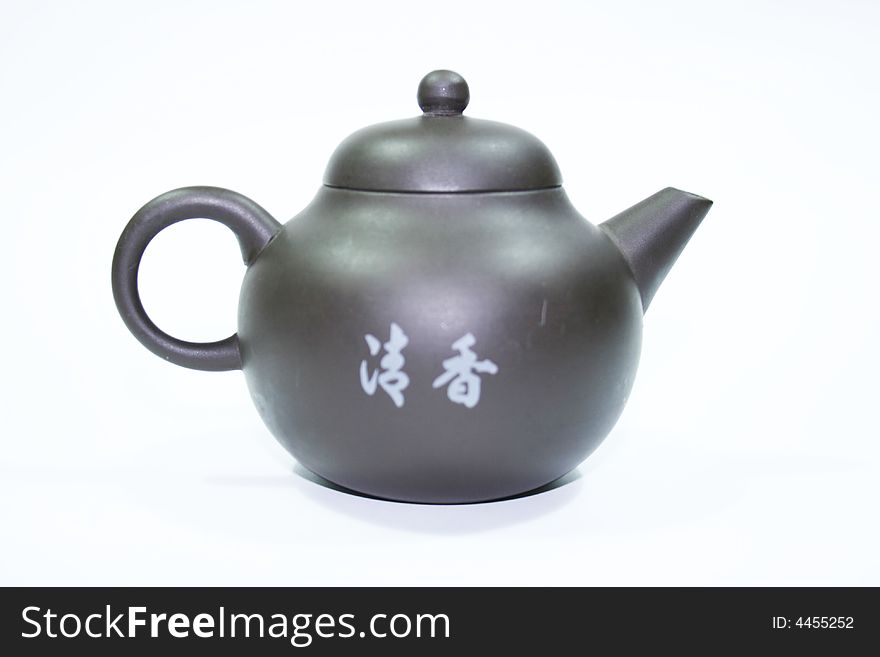 Isolated chinese teapot made of brown clay