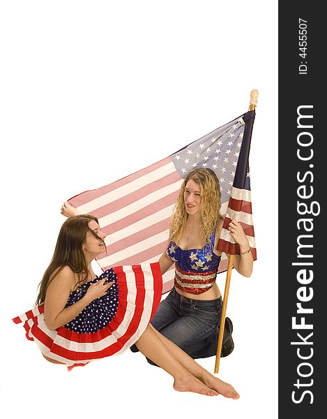 Attractive female American patriots with flag isolated over white having fun. Attractive female American patriots with flag isolated over white having fun