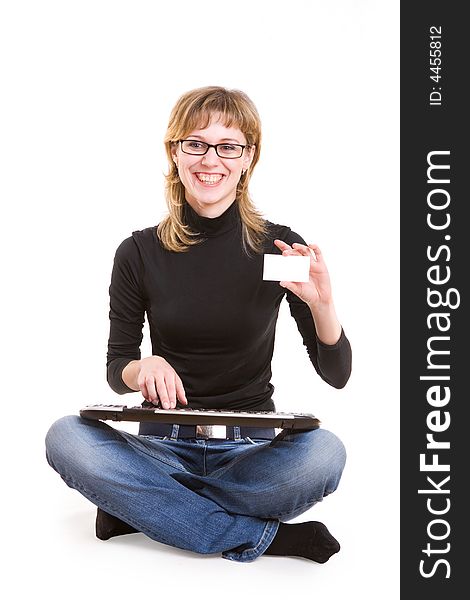 A girl with a keyboard and a card for text in her hand. A girl with a keyboard and a card for text in her hand