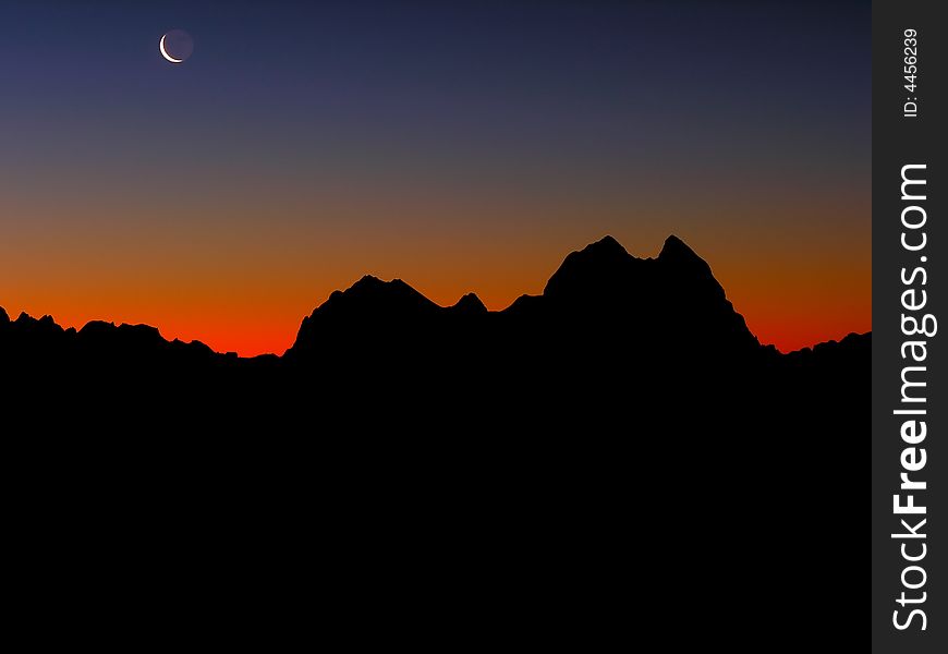 Silhouette  of a mountain chain on a background of a decline. Silhouette  of a mountain chain on a background of a decline