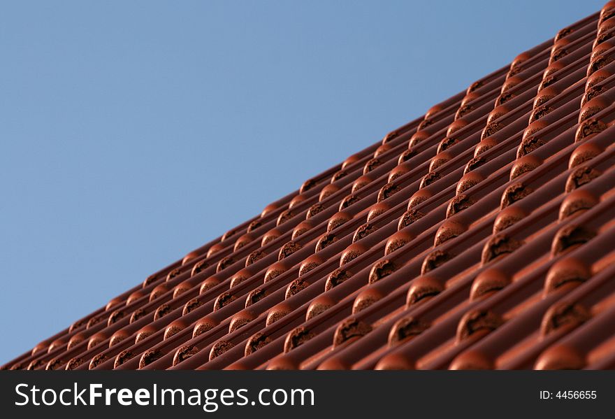 Blue sky and roof tiles in perspective view.