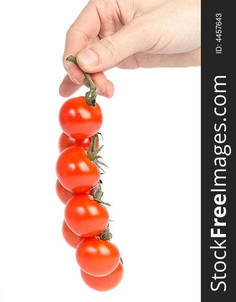 Hand with small cherry tomatoes