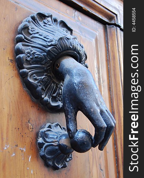 A bronze doorknocker with hand. A bronze doorknocker with hand