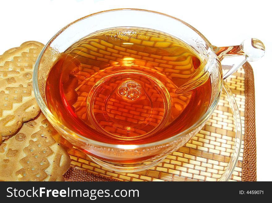 Transparent cup of tea and cookies on a white background. Transparent cup of tea and cookies on a white background