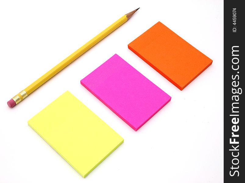 The adhesive notes besides a pencil on a white surface. The adhesive notes besides a pencil on a white surface