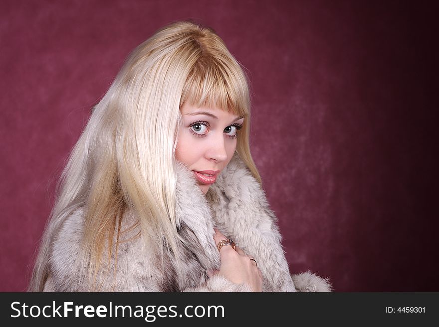 Portrait of the nice girl in fur coat